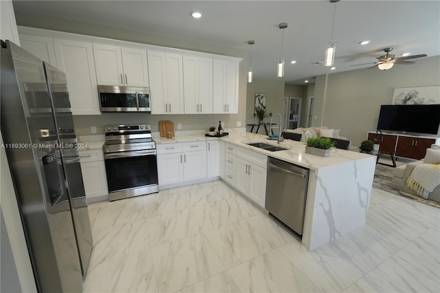 kitchen with kitchen peninsula, stainless steel appliances, white cabinetry, and sink