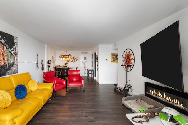 living room with dark hardwood / wood-style flooring and a chandelier