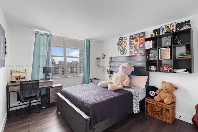 bedroom with dark hardwood / wood-style floors