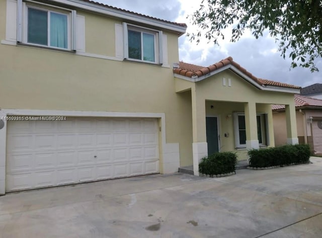 mediterranean / spanish house featuring a garage