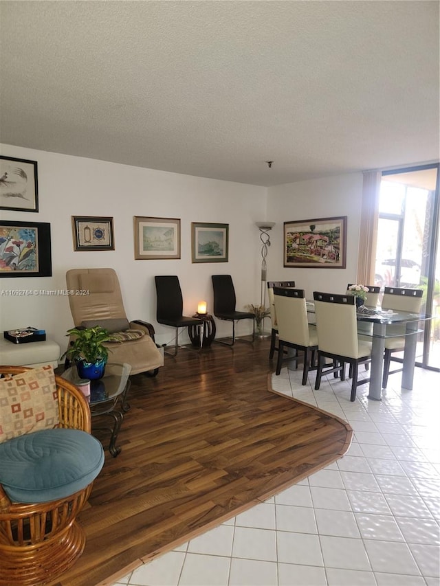 living room featuring light wood-type flooring and a textured ceiling