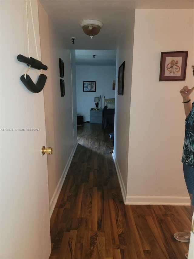 corridor with dark wood-type flooring