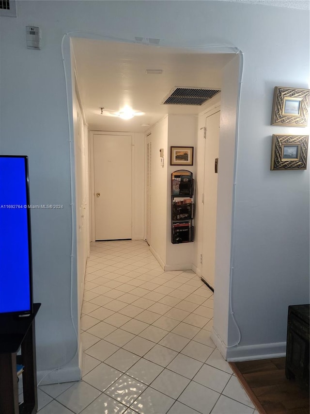 hallway with light tile patterned floors