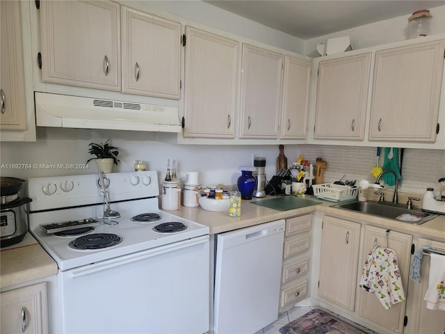 kitchen with sink, white appliances, and backsplash