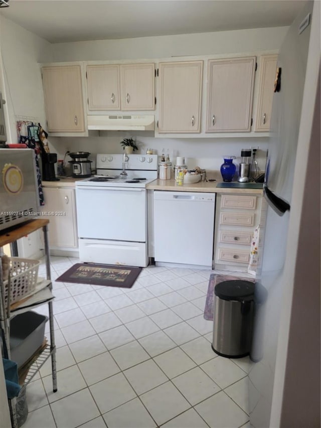 kitchen with light tile patterned floors and white appliances