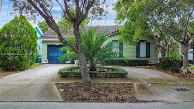 view of property hidden behind natural elements with a garage