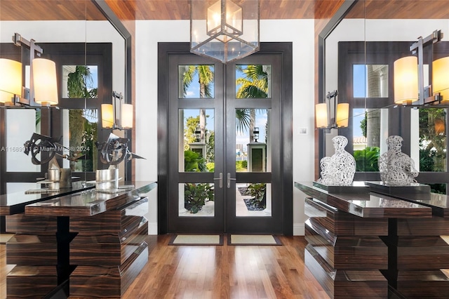 foyer entrance featuring wood-type flooring, french doors, and wooden ceiling