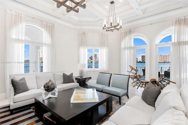 living room featuring beamed ceiling, a water view, a healthy amount of sunlight, and coffered ceiling