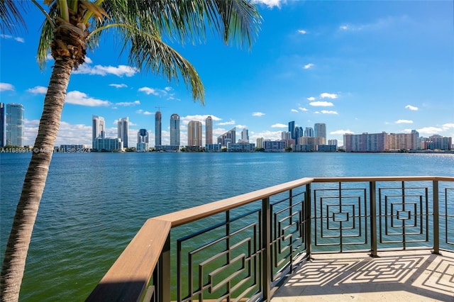 view of dock with a balcony and a water view