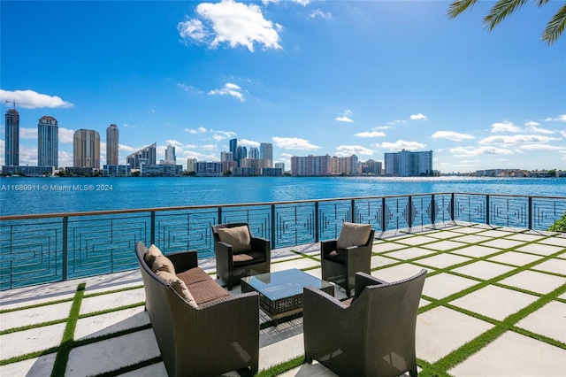 view of patio / terrace with a balcony and a water view