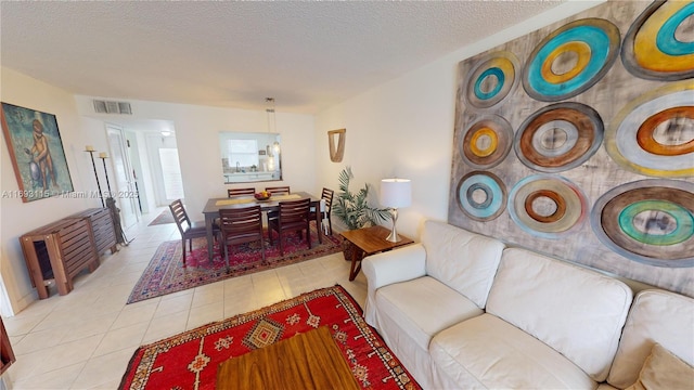 living room with light tile patterned floors and a textured ceiling