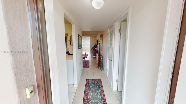 corridor featuring light tile patterned floors