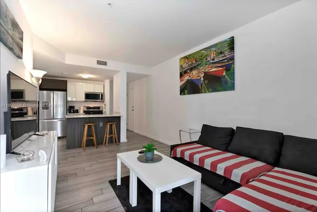 living room with light hardwood / wood-style flooring