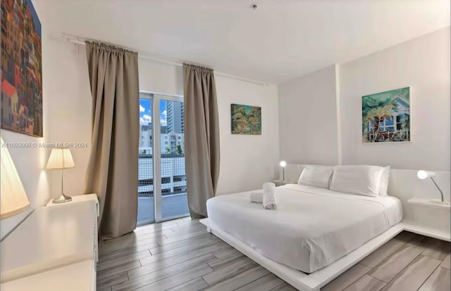 bedroom featuring access to outside and wood-type flooring