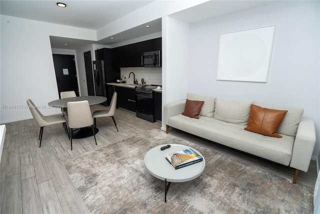 living room featuring hardwood / wood-style flooring and sink