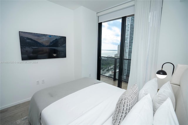 398 NE 5th St Unit 1617, Miami, FL 33132 - bedroom featuring wood finished floors, access to exterior, and baseboards