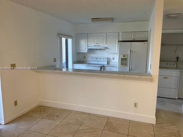 kitchen featuring white appliances and washer and dryer