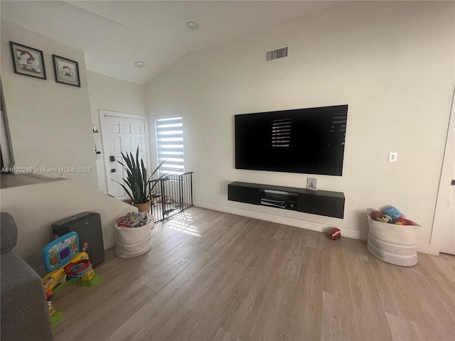 living room with hardwood / wood-style flooring and lofted ceiling