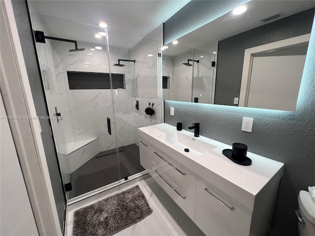 bathroom featuring walk in shower and vanity