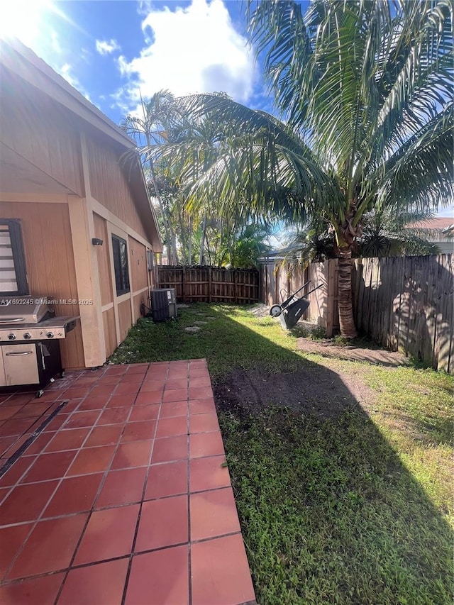 view of yard featuring a patio area and central AC