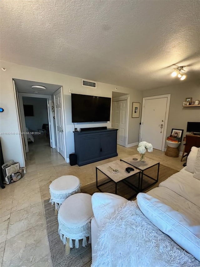 living room with a textured ceiling