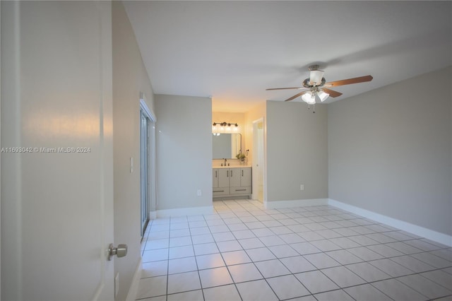 unfurnished room with ceiling fan and light tile patterned floors