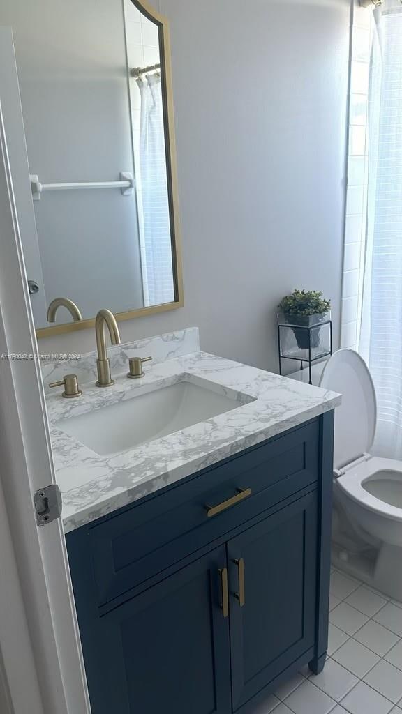 bathroom with tile patterned floors, vanity, and toilet