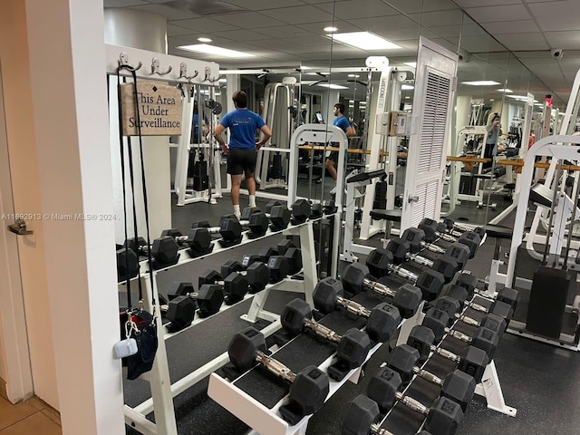 gym featuring a paneled ceiling