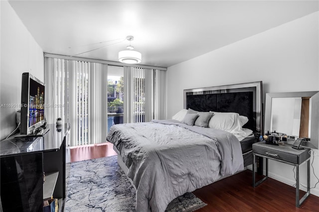 bedroom with dark wood-type flooring