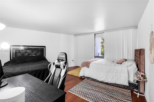 bedroom with dark hardwood / wood-style flooring