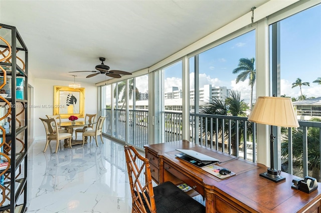 sunroom / solarium featuring ceiling fan