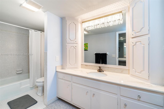 full bathroom with tile patterned floors, vanity, shower / bath combo with shower curtain, and toilet