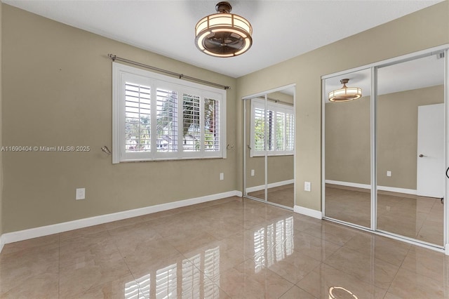 unfurnished bedroom featuring multiple closets