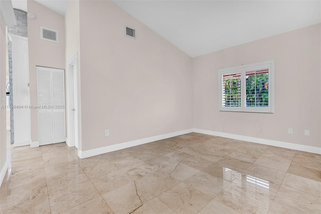 empty room featuring lofted ceiling