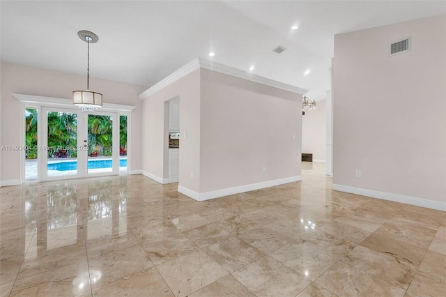 unfurnished room featuring crown molding and french doors