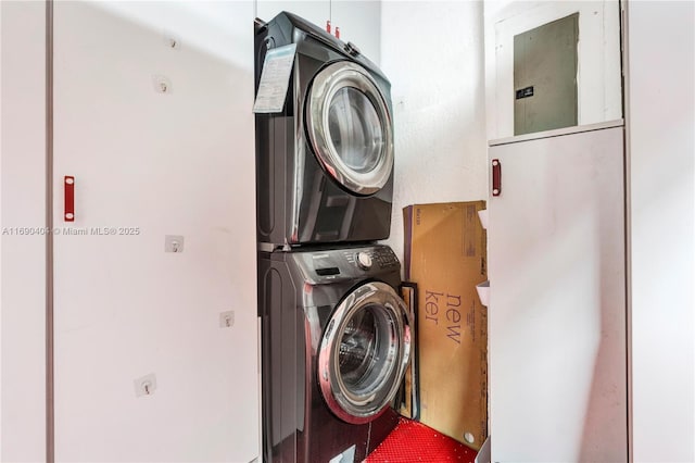 clothes washing area featuring stacked washer / dryer