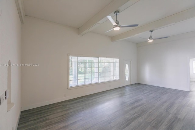 empty room with dark wood-type flooring, ceiling fan, and beam ceiling