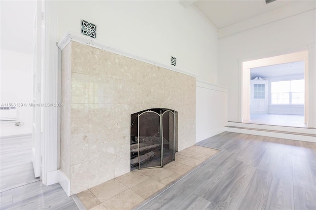 interior details featuring a fireplace and wood-type flooring