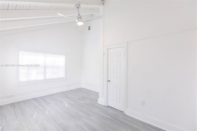 empty room with light hardwood / wood-style floors, vaulted ceiling with beams, and wooden ceiling