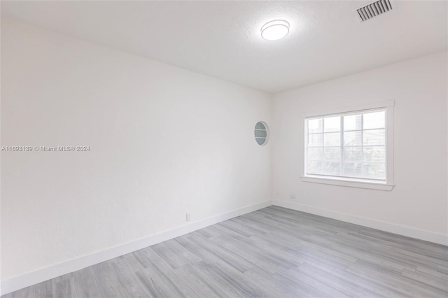 spare room with light hardwood / wood-style flooring