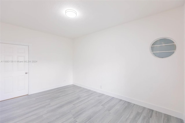 spare room featuring light hardwood / wood-style flooring