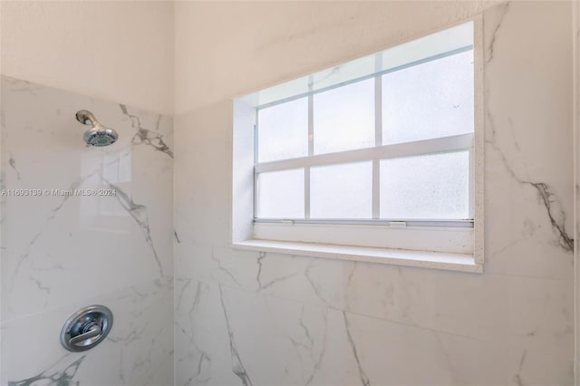 bathroom with a tile shower