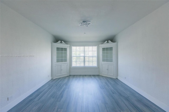 empty room with dark hardwood / wood-style flooring