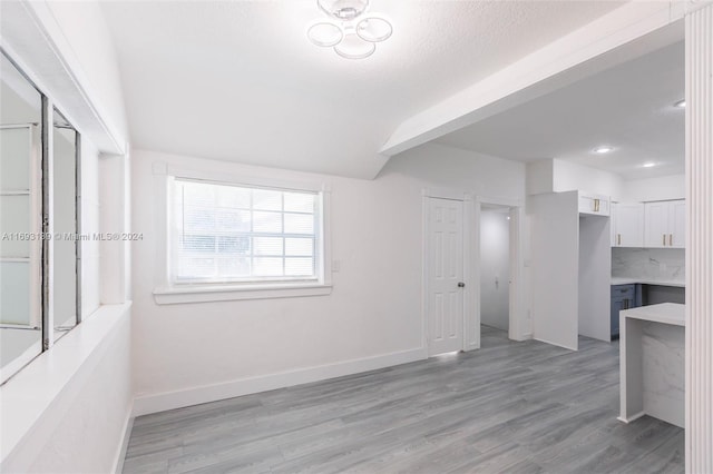 interior space featuring light hardwood / wood-style floors and beam ceiling