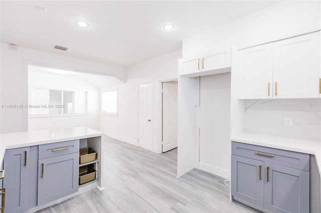 kitchen with white cabinets and light hardwood / wood-style floors