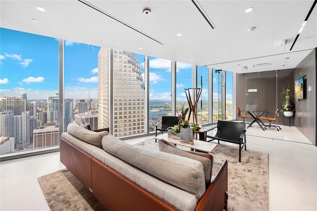 living room featuring concrete flooring and a wall of windows