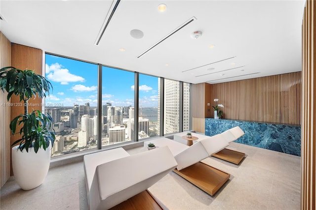 bedroom featuring wood walls and expansive windows