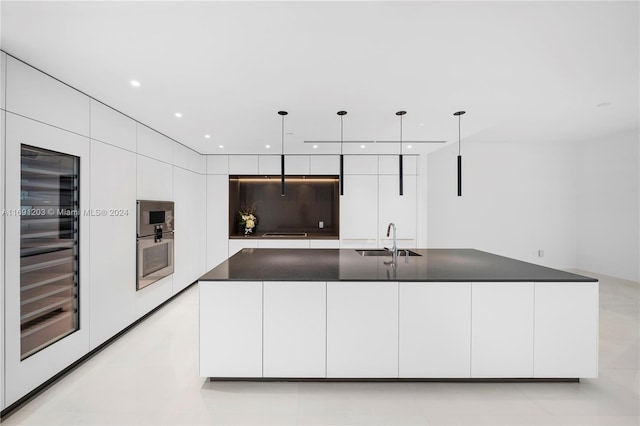 kitchen with white cabinets, sink, a large island, pendant lighting, and wine cooler