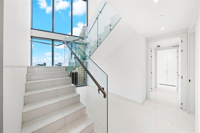 staircase featuring tile patterned floors