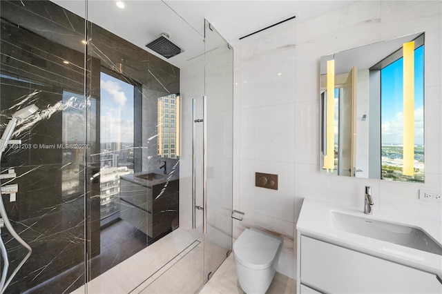 bathroom featuring walk in shower, vanity, toilet, and tile walls